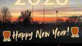 Image is a photo of Biggleswade Rugby Club's first team pitch at sunset with a Happy New Year Message superimposed over the top